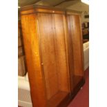 A pair of contemporary mahogany freestanding open bookshelves, each having dentil moulded cornice,