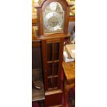 A mahogany Tempus Fugit grandmother clock, having an arched silvered and brass dial, glazed trunk