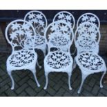 A set of six contemporary white painted floral pierced and pressed metal garden chairs