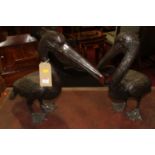A pair of contemporary bronzed metal models of pelicans, the larger height 55cm