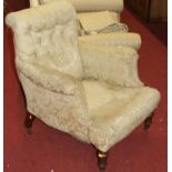 A Victorian mahogany framed and floral silk damask buttonback upholstered armchair, raised on turned