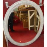 A painted and moulded wooden oval wall mirror, early 20th century, 115 x 90cm