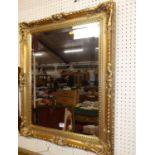 A contemporary floral gilt decorated bevelled rectangular wall mirror, 75 x 59cm