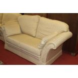 A contemporary three-piece suite by Rhodabourne Upholstery, cream upholstered, comprising three-