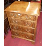 A mahogany chest of three long graduated drawers, having hinged upper compartment in the form of a