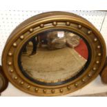 An early 20th century gilt decorated circular convex wall mirror, in the Regency taste, dia.62cm