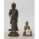 An Eastern brass figure of a deity, h.27cm; together with one other
