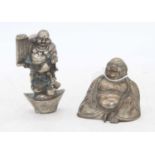 An Eastern white metal model of a seated deity, h.7cm; together with one other similar