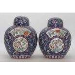 A pair of Chinese ginger jars and covers, each of globular form, enamel decorated with flowers, h.