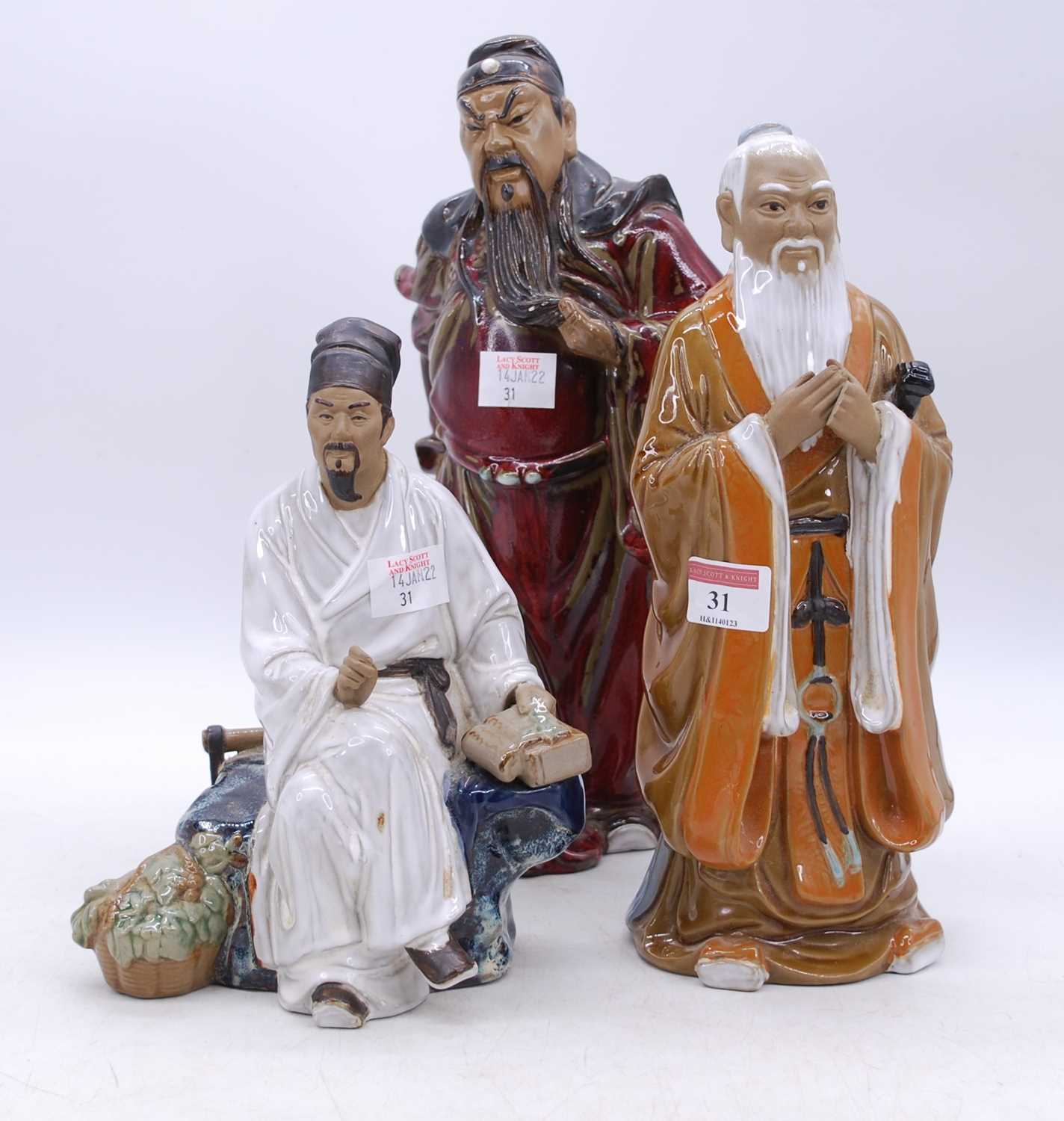 Three Chinese 'mudman' style figures of gentleman, the largest h.33cm