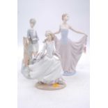 A Lladro porcelain figure of a female dancer, h.25cm; together with two further Lladro figures (3)