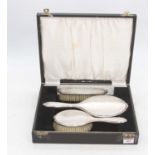 An Elizabeth II silver backed three-piece dressing table set, Birmingham 1972, cased