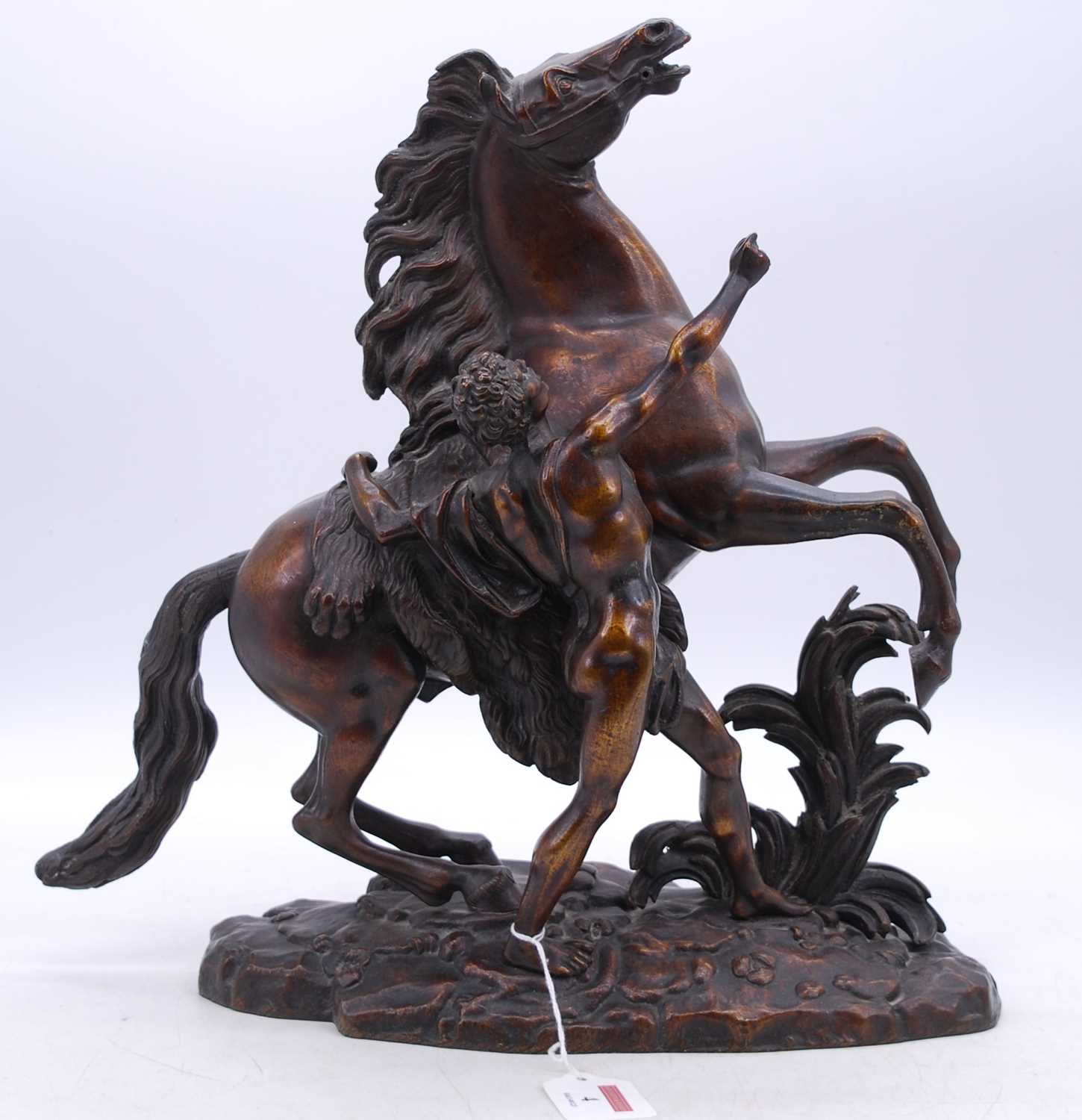 After Guillaume Coustou - a late 19th century bronze model of a Marly Horse, modelled with groom