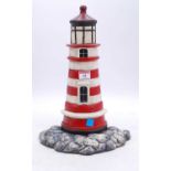 A cast iron doorstop in the form of a lighthouse, h.38cm