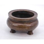 A reproduction Chinese bronze tripod censor, six character mark to the underside, dia.16cm