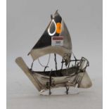 An Arabian white metal model of a dhow boat, mounted upon a presentation stand, stamped silver to