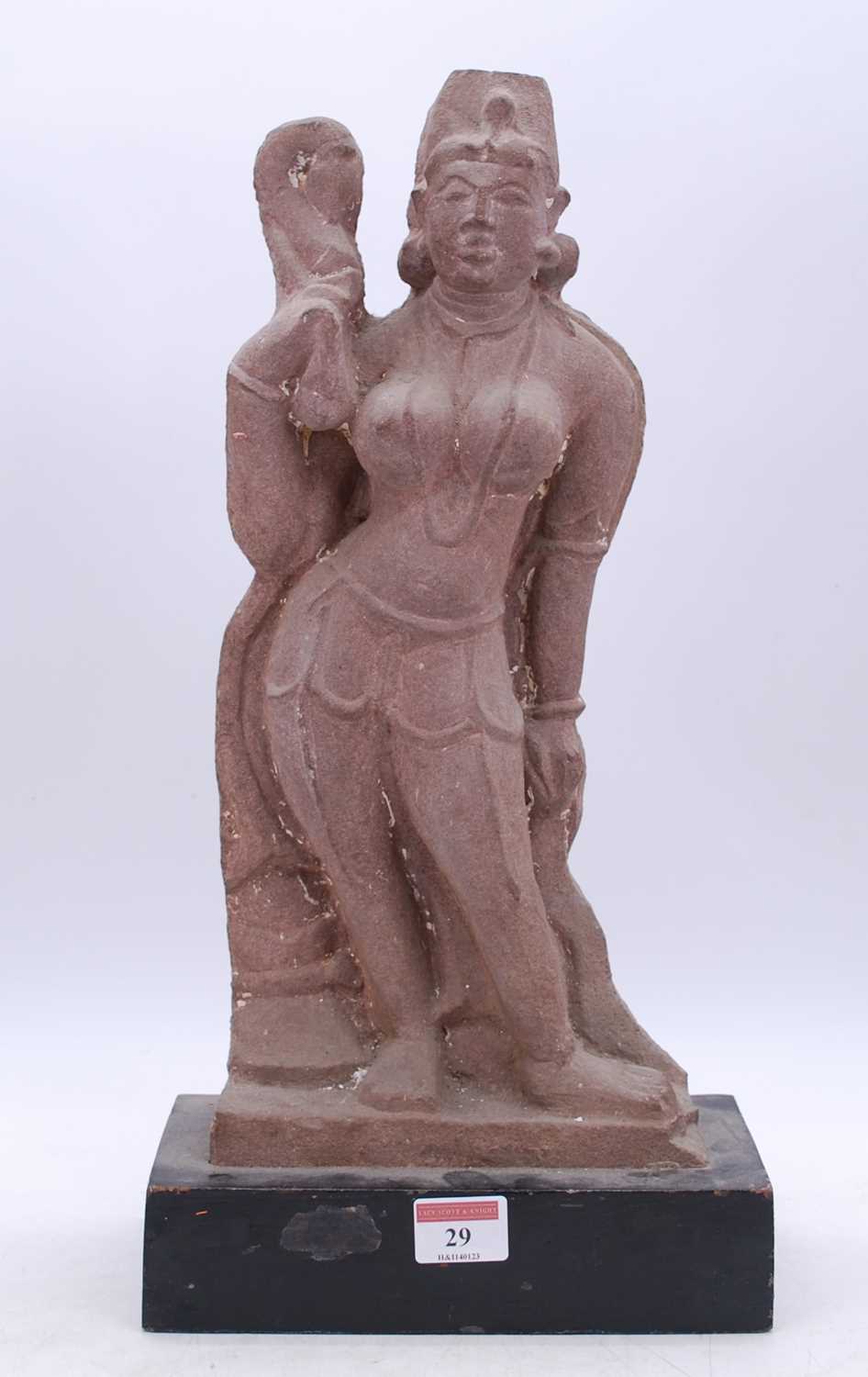 An Eastern carved sandstone figure of a lady, mounted upon an ebonised plinth, h.43cm