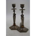 A pair of Regency style plated table candlesticks, the sconce above an Egyptian influenced stem, h.