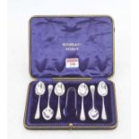 A set of six Edward VII silver teaspoons and sugar nips, cased