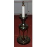 A large 20th century brass table lamp, standing upon a tripod base and ebonised plinth, h.84cm