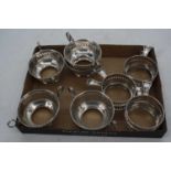A set of five pierced sterling silver mounts, each flanked by twin handles; together with a set of