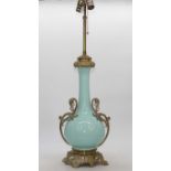 A 20th century celadon glazed and brass mounted table lamp, h.81cmNeeds re-wiring.Mounts are a