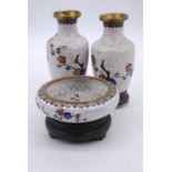 A pair of Chinese cloisonne enamel decorated vases and stands, h.19cm; together with a matching