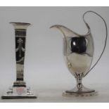 A 19th century silver table candlestick, loaded, h.16.5cm; together with a white metal milk jug,
