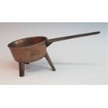 An 18th century bronze tripod skillet, the handle inscribed Robert Street & Co, 38cm