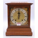 An early 20th century oak cased bracket clock, the silvered chapter ring showing Roman numerals
