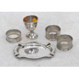 A George V silver pin tray, Birmingham 1917, w.11cm; together with a silver egg-cup and three napkin