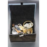 A glass bound jewellery box and contents to include a collection of a lady's and gents fashion