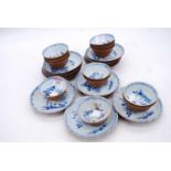 A set of twelve mid 18th century Chinese blue and white tea bowls and saucer, each bearing a paper