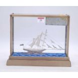 A filigree work model of a ship, housed in a glazed display case, overall h.23cm