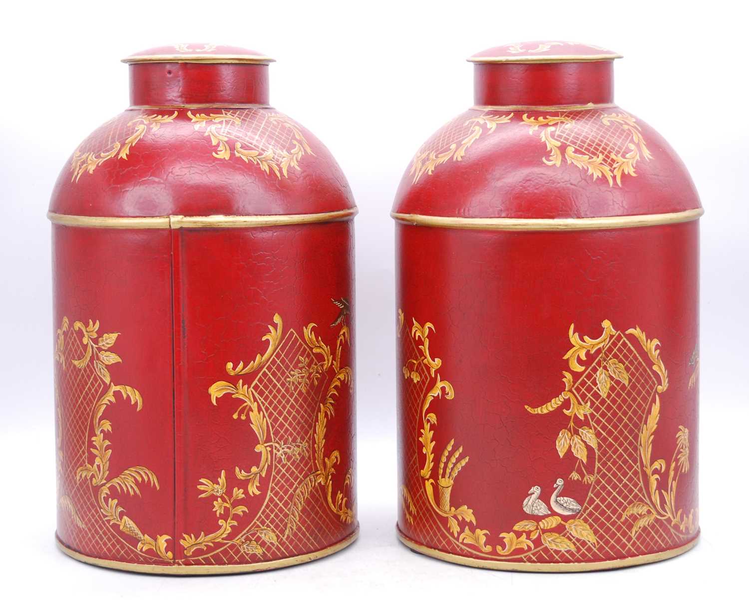 A pair of reproduction red toleware type tea canisters, h.36cm