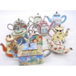 A collection of Eastern enamel decorated teapots, the largest h.9cm