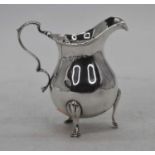 A Victorian silver milk jug, standing upon three hoof feet, London 1900, 3.8ozt, h.10cm
