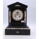 A Victorian black slate mantel clock, of architectural form, the enamelled chapter ring showing