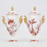 A pair of Coalport Indian Tree Coral pattern porcelain urns, height 21cmCracks to handles on both.