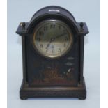 An early 20th century mantel clock, the brass dial showing Arabic numerals, the black lacquered case