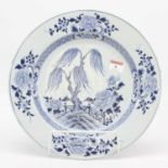 An 18th century Chinese blue and white porcelain charger, decorated with a willow before a fence,