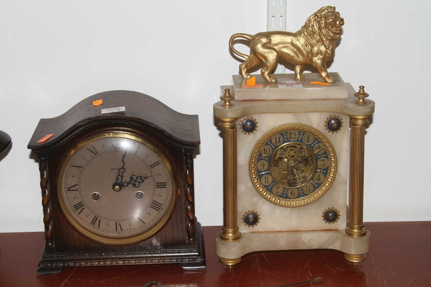 An early 20th century mantel clock, surmounted by a gilt painted lion (a/f), together with a 1930s