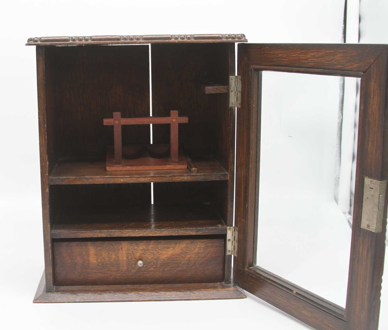 An early 20th century oak smoker's cabinet, the glazed door opening to reveal an arrangement of - Image 2 of 2