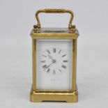 An early 20th century brass cased carriage clock, the enamel dial showing Roman numerals, signed