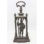 A Victorian cast iron door stop in the form of a knight under an arch, marked Coalbrookdale to the