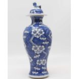 A Chinese blue glazed vase and cover, of baluster form, decorated with prunus blossom, height