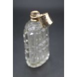 A 19th century cut glass scent bottle, having finely engraved yellow metal hinged cap, 8.7cmNo