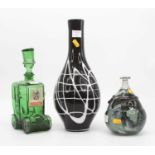 A green glass vase, height 18cm, together with a black & white glass vase, and a novelty decanter