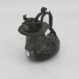 An eastern verdigris bronze ewer, having a scrolled handle, h.17cm