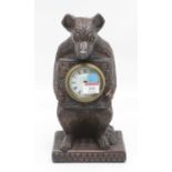 A Black Forest style mantel clock, carved in the form of a bear, height 30cm